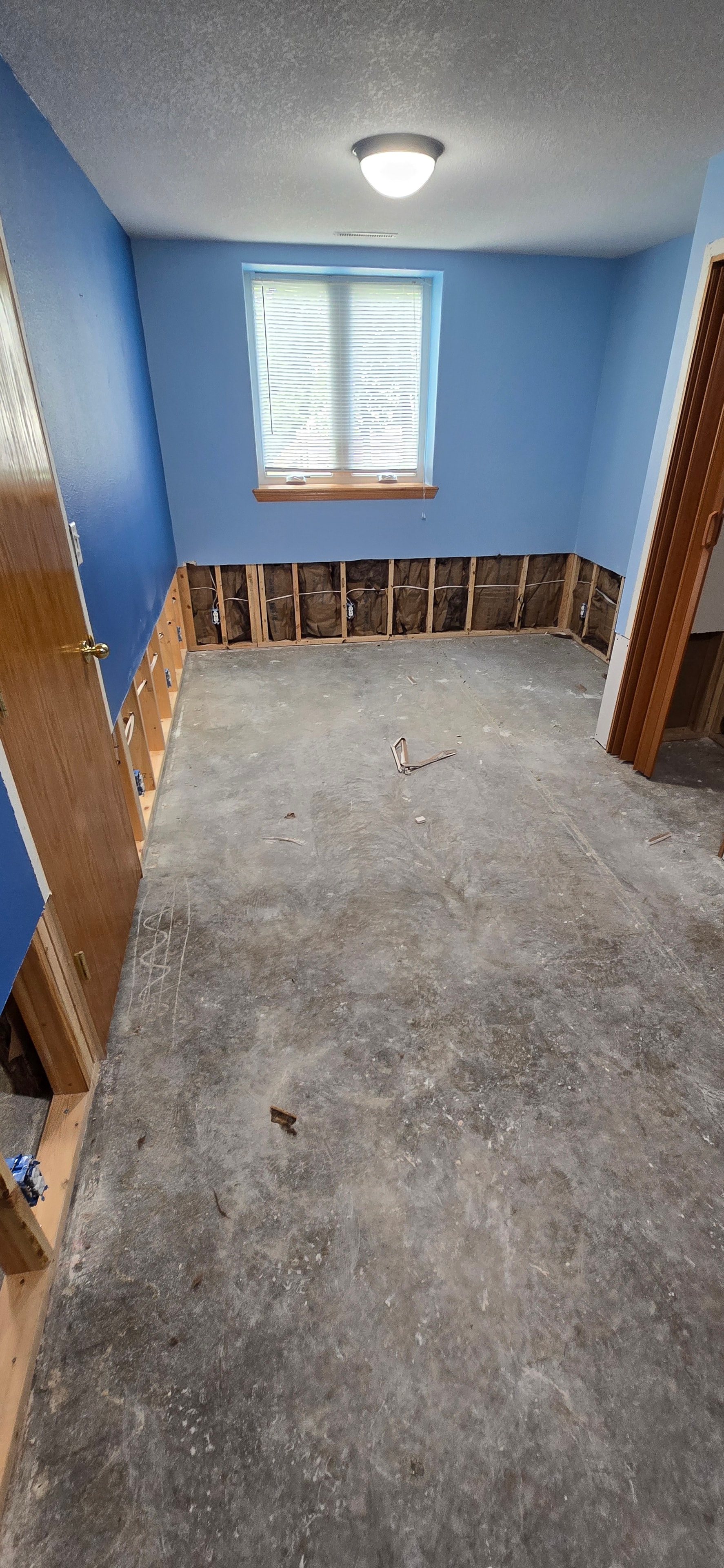 Basement bedroom before drywall repair — H&H Construction Services