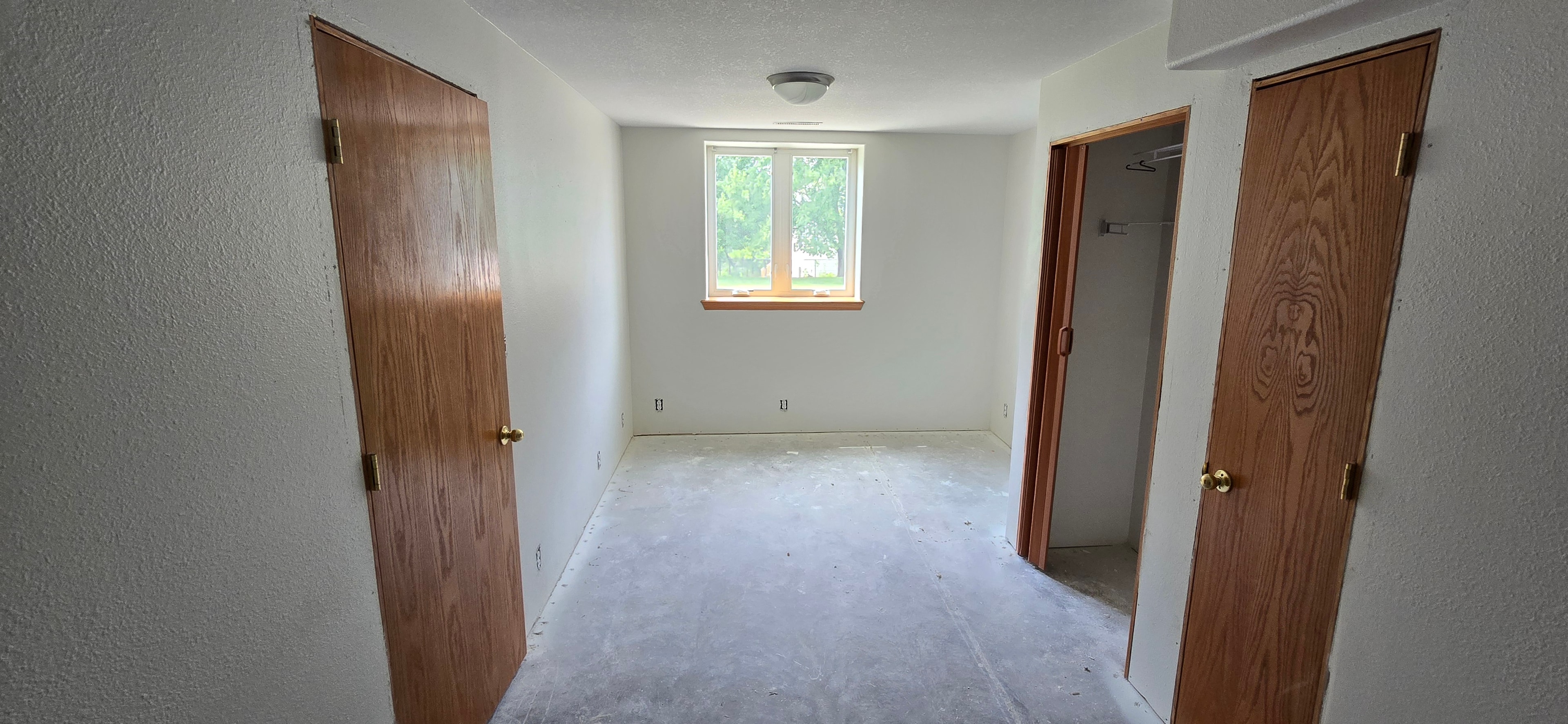 Basement bedroom during painting — H&H Construction Services